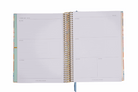 Open spiral-bound planner with lined pages on a white background